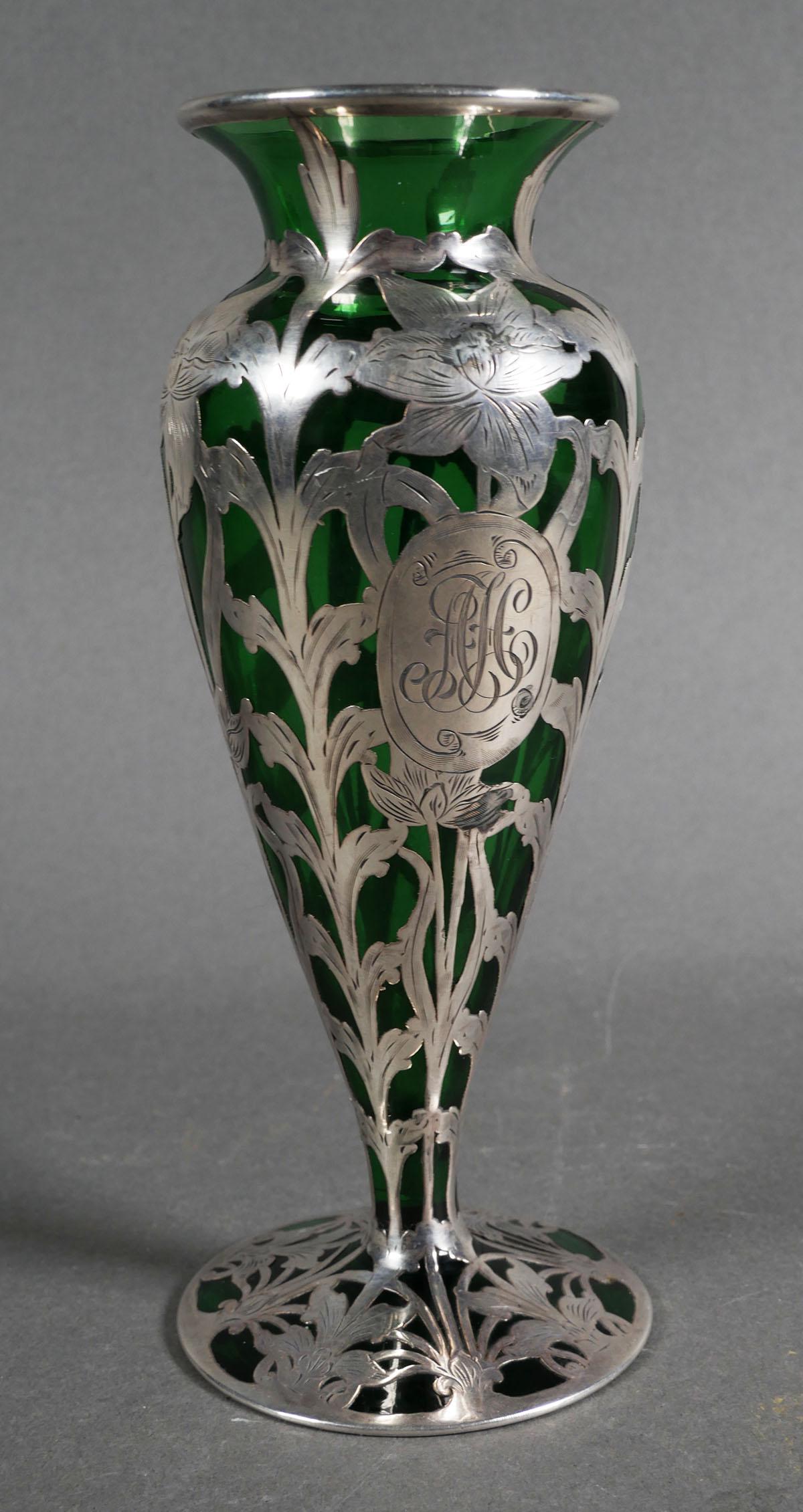 Antique Art Nouveau Glass Silver Vase: Art nouveau silver overlay on green glass vase, possibly Loetz (Austrian), monogram engraved on cartouche on one side, measures 8 inches high. This item can be shipped in-house.
