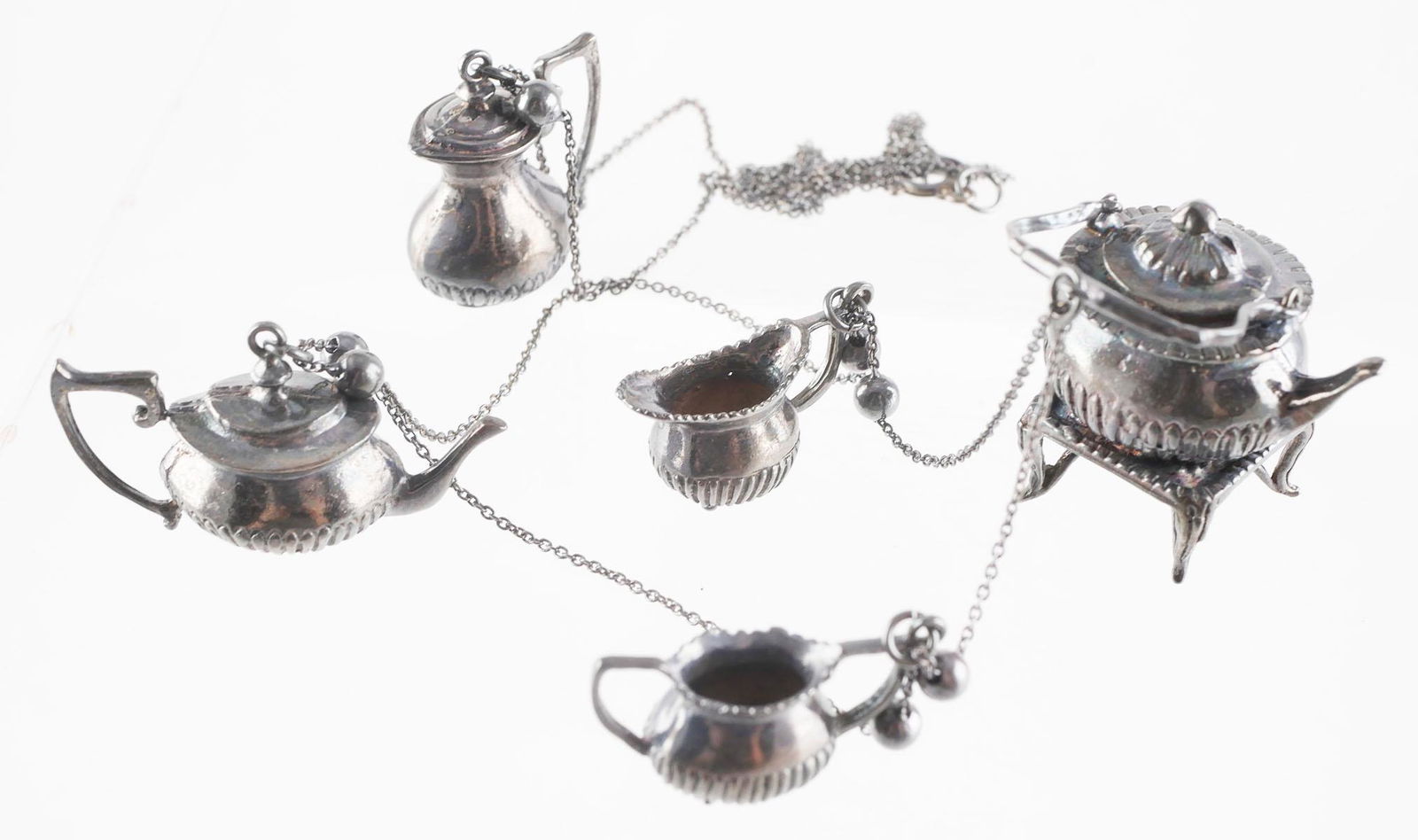 DOLLHOUSE STERLING MINIATURES NECKLACE: Vintage sterling silver dollhouse miniature tea set made into a necklace. This item can be shipped in-house.