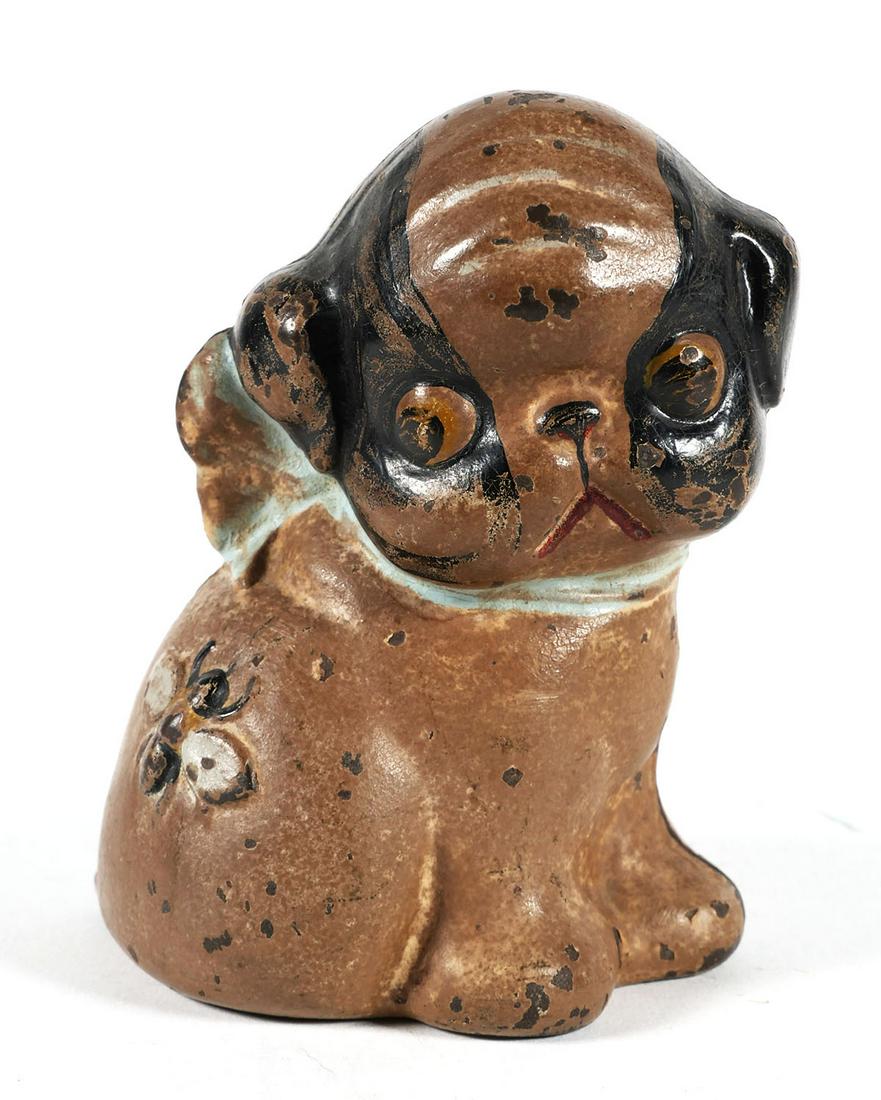 Cast Iron Hubley Puppo Bank: Cast iron bank in the shape of a Boston terrier with a bee on its hip, measuring 5 inches in height. This item can be shipped in-house.