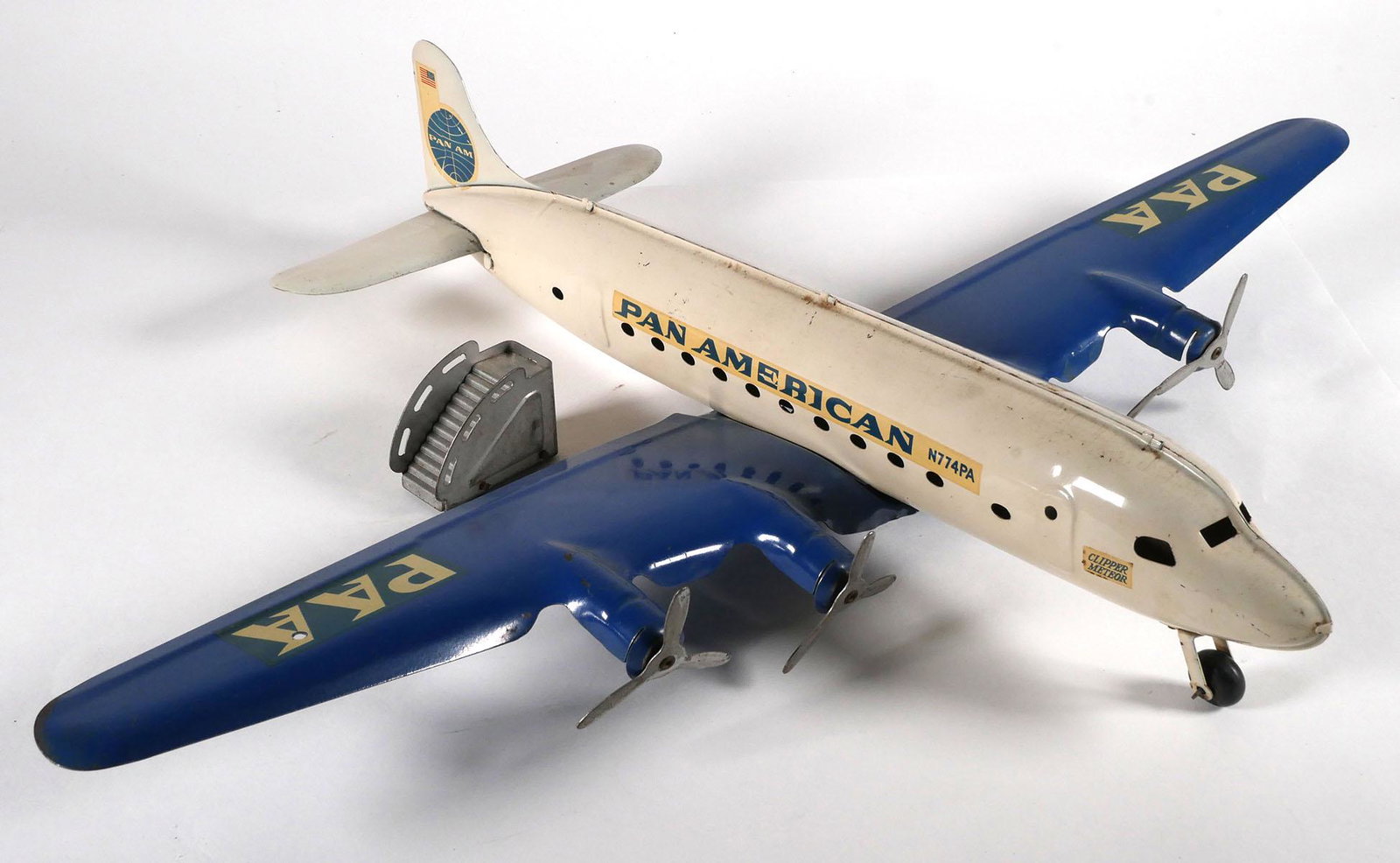 Vintage Marx Pan American Toy Plane: Clipper Meteor N774PA Pan American MARX plane toy plane, pressed steel, wing span measures 27 1/2 inches, plane length measures 21 1/2 inches. This item will need to be shipped by a packing company of