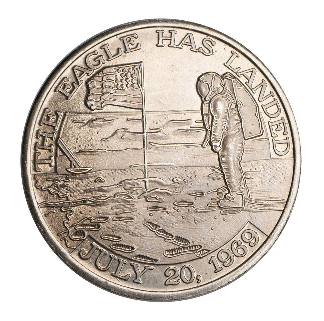 APOLLO 11 Coin SPACE FLOWN: Flight Awareness Medallion commemorating the Apollo 11 mission from the collection of a NASA employee and associate of Wernher von Braun. Well-struck on both sides. One side reads "The Eagle Has Lande