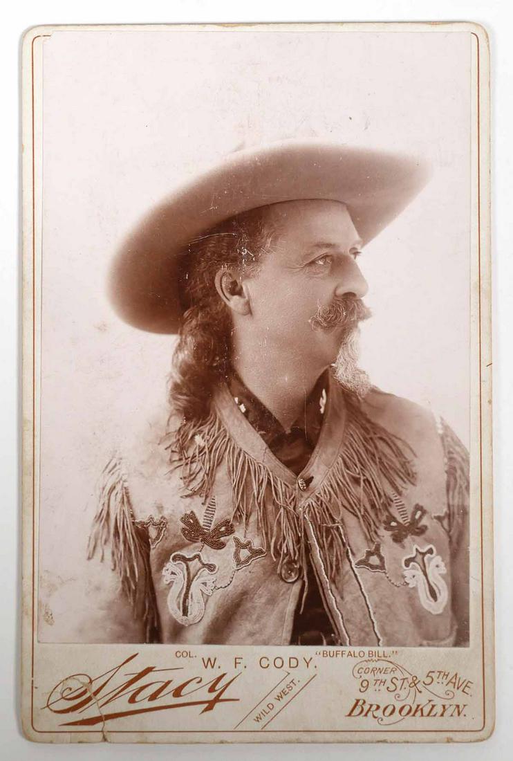 BUFFALO BILL CODY Cabinet Card: Cabinet card photograph of William Frederick Cody by Stacy Studios, Brooklyn, New York. C. 1900 image showing Cody in his Stetson hat and a beaded fringed buckskin jacket. Facsimile signature on verso