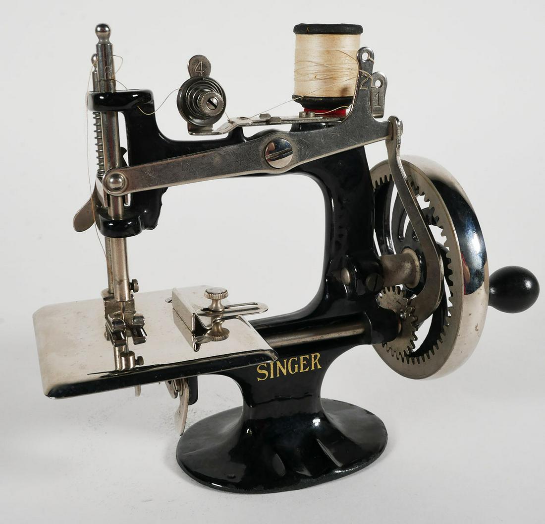 Antique Singer Sewing Machine No. 20: Singer Child's Sewing Machine no. 20 with original box with instruction manual and needles, box measures 4 x 7 x 7 1/2 inches. This item can be shipped in-house.