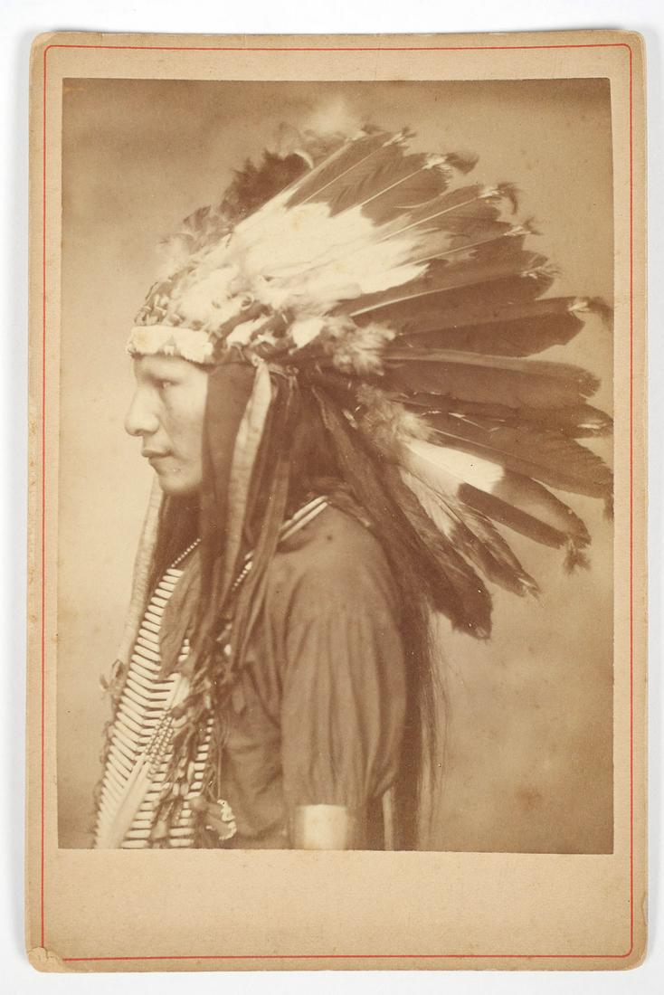 Buffalo Bill's Wild West Show Cabinet Card: Stamped on the back "Goplo 55. Avenue Des Ternes, 55 Paris". Profile portrait of a young Native American man, part of the group of Show Indians hired by William Frederick Cody to participate in the Wi