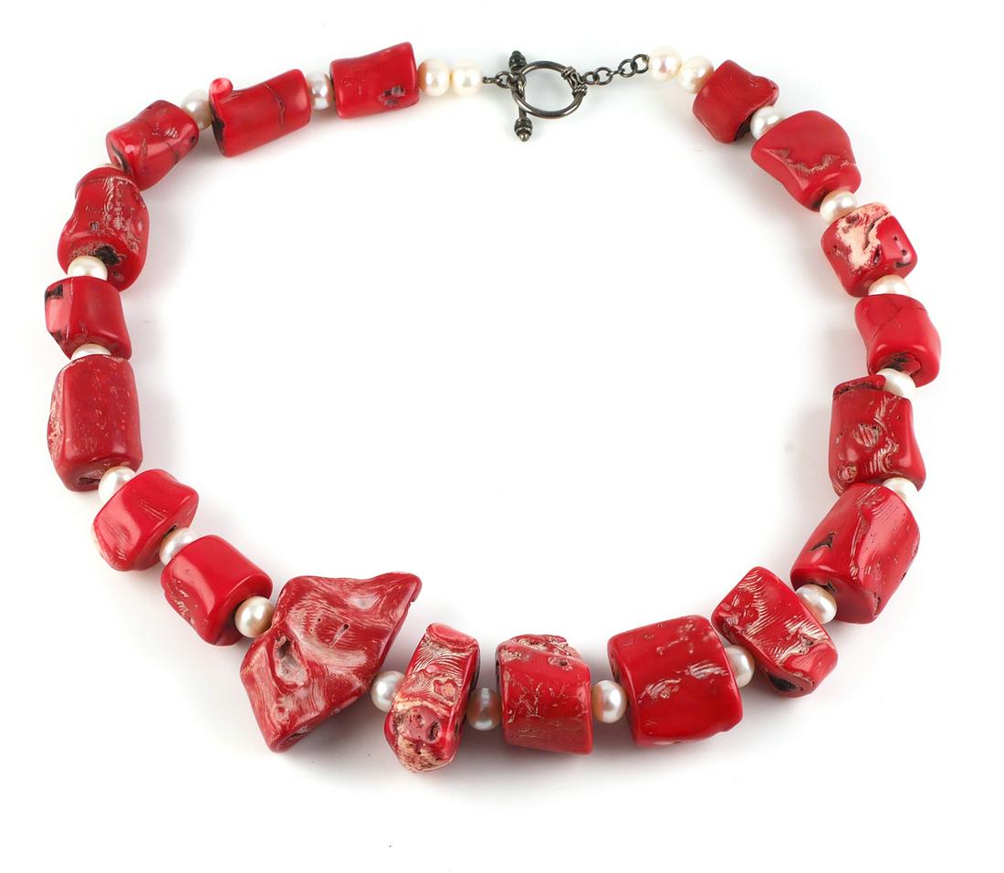 Vintage Chucky Coral and Pearl Necklace: Large Statement necklace of chunks of coral strung with pearls and sterling clasp, length of necklace measuring 25" long, largest coral piece 2" x 1 1/8" (HW) This item can be shipped in-house.