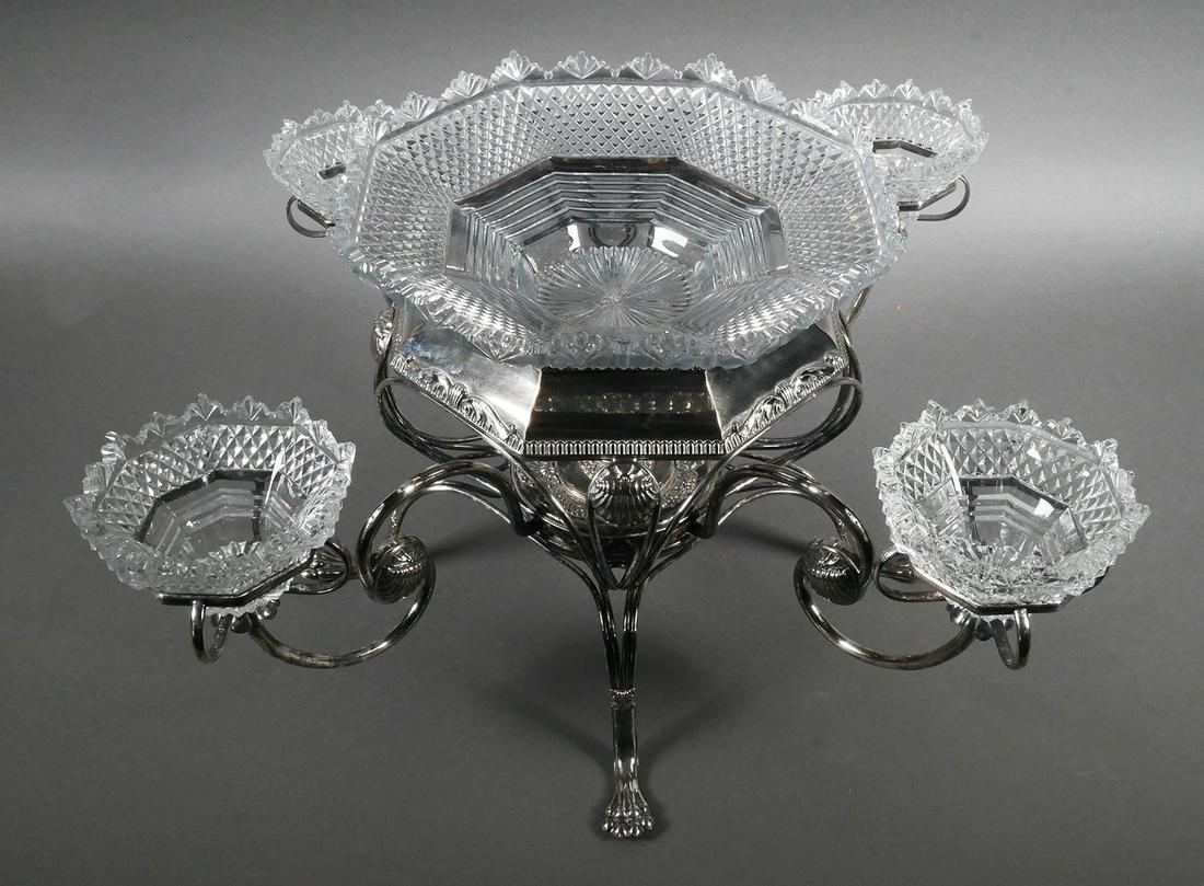 Antique Crystal and Silver Plate Epergne: Silver plate epergne with 4 small crystal octagonal shaped bowls and large crystal center bowl, 19th century, possibly English. Piece measures 10" x 21" x 21" (HWD). This item will need to be shipped 