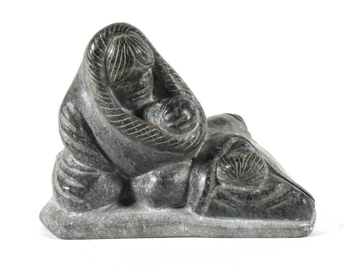 20th C. Eskimo Carving of a Family: Large hand carved Esquimau Inuit stone sculpture depicting a mother holding a child with a sleeping figure next to them. Incised on the underside of the base and having two paper tags. Approx. 8-3/4"x