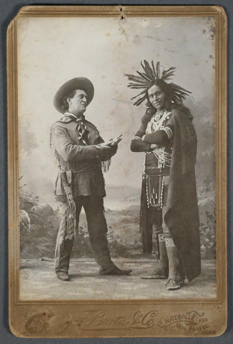 Native American and Interpreter Cabinet Card: This pair is found in an unusual pose with a Frontiersman interpreter wearing a kerchief over a hide tunic with fringe and trousers is making what may be a Native American Indian sign language gesture