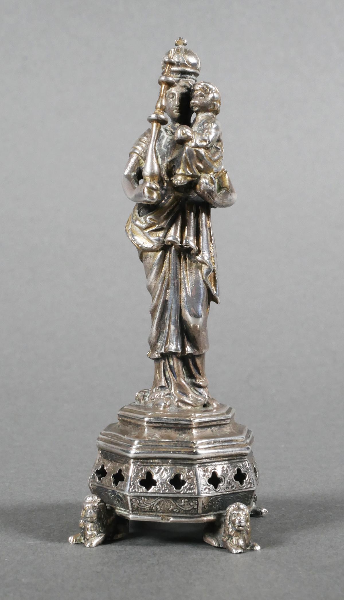 Antique Continental Silver Virgin and Child Figure: Standing Virgin Mary wearing a crown, scepter in one hand and cradling Jesus as a child in the other arm. Standing on a tiered base with reticulated quatrefoil design, supported by figural feet in the