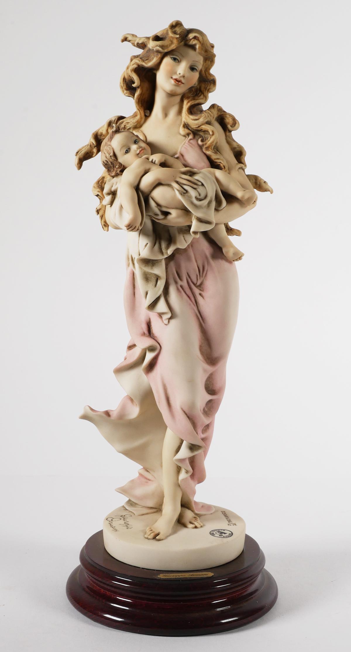 Giuseppe Armani Figurine 880E LOVING ARMS: Giuseppe Armani figurine titled "LOVING ARMS" is numbered 880E and is the 1993 event figure. Signed and stands about 14" tall. Comes with an Armani box but we aren't positive that it is the original b