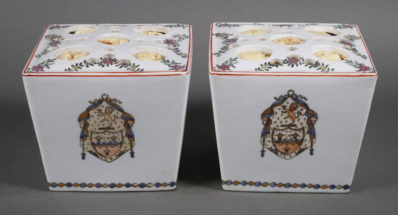19 C French Faience Bough Pots: Pair of antique armorial motif polychrome flower holders bouquetiere pots. Tops decorated with flowering branches, the sides decorated in an alternating manner with flowering branches and a coat of ar