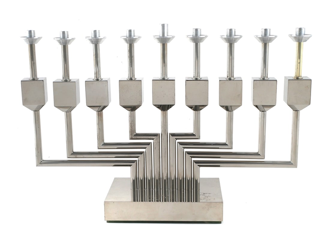 Yaacov AGAM Silver Menorah Sculpture: Kinetic menorah with spinning dreidel design on each sculpture by Yaacov Agam, titled "Candelabragam Menorah", stainless steel, signed on base, numbered 142/225, measuring 9-1/2" x 14-1/2" x 4" This i
