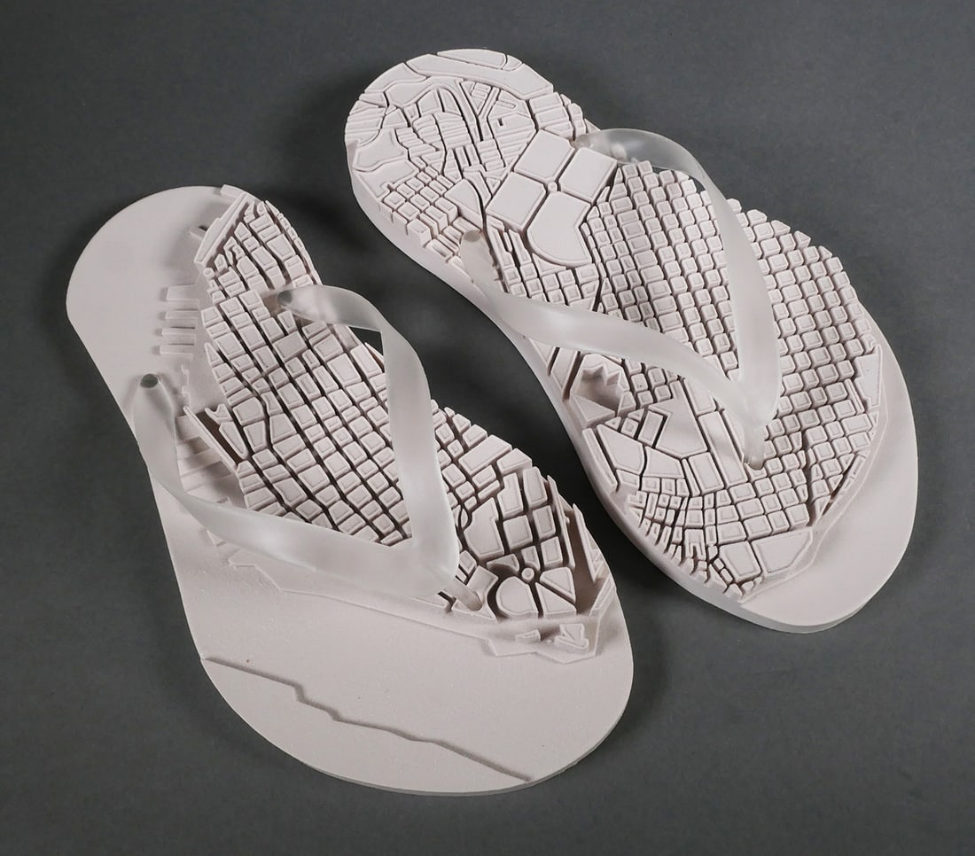 LOS CARPINTEROS Sandalia Sculpture: Two cast rubber sandal sculptures with the map of Havana on the top face of the sole, by the Cuban based artist collective Los Carpinteros. The work was done in collaboration with USF Graphic Studio,