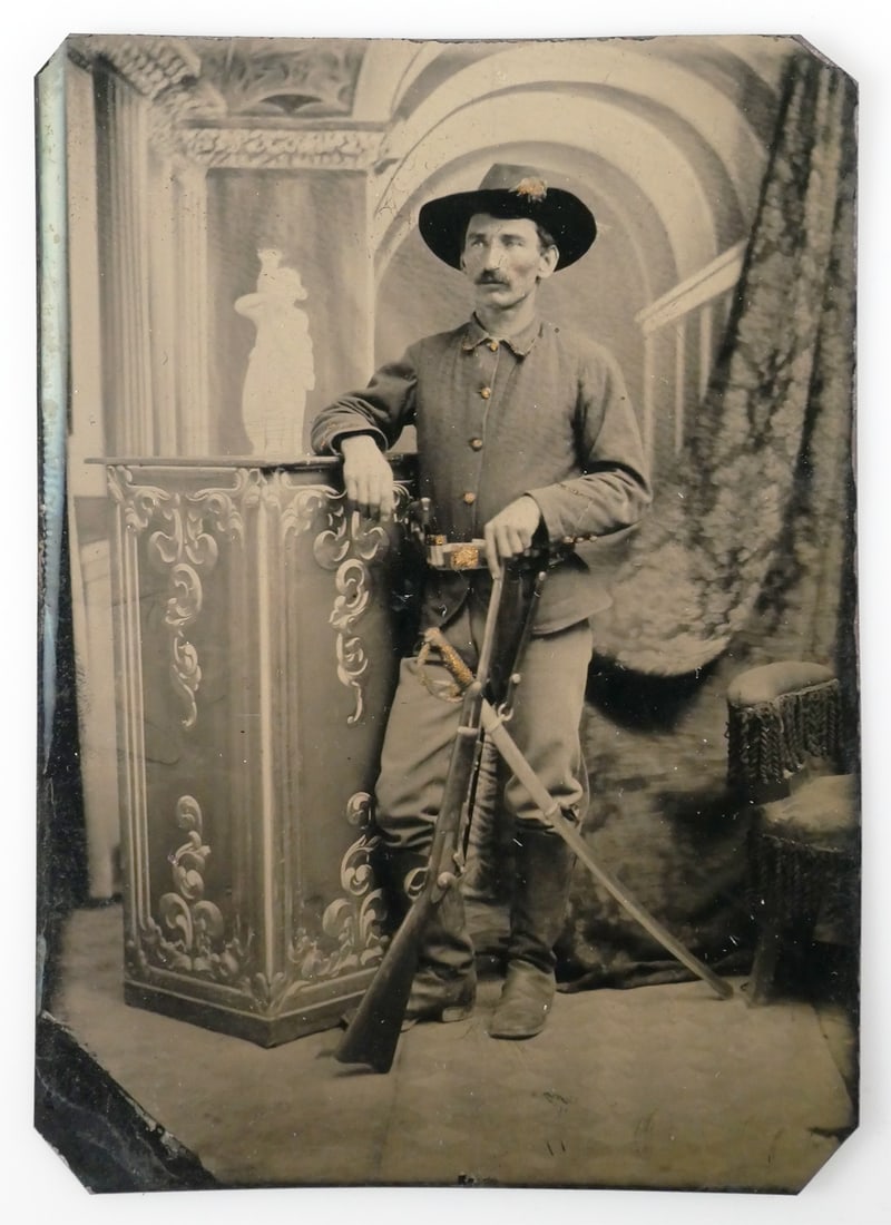 Gen. CUSTER Period Cavalry Soldier Tintype: Very fine 1/6th plate tintype of an 1870s cavalry soldier. Studio pose with 1873 Springfield carbine, boots and hat. Butt end of pistol visible in belt. Measures 3-3/8" x 2-3/8". This item can be ship