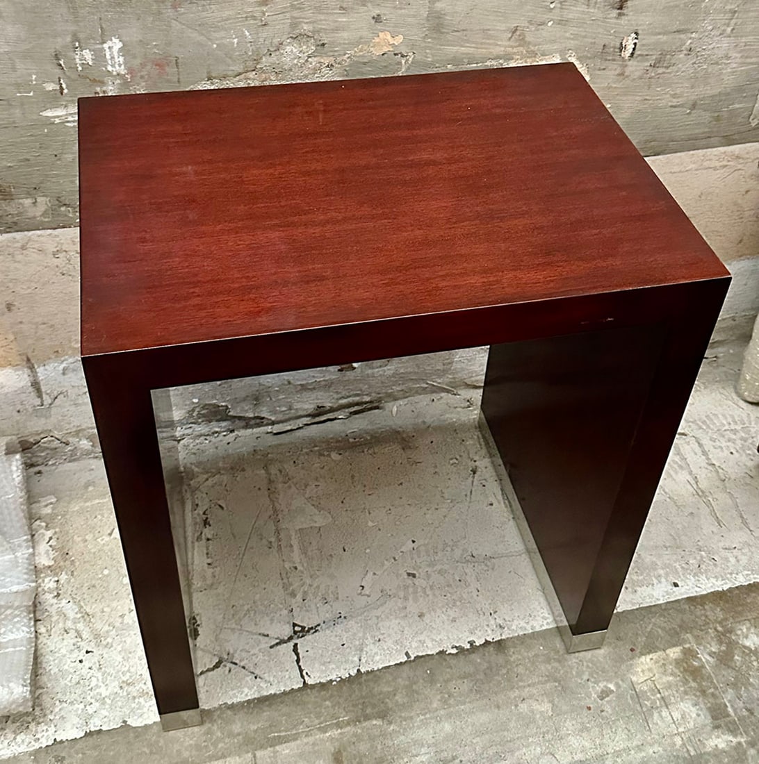 Ralph Lauren Brook Street End Table: The sleek design of this end table is emphasized with a polished mahogany finish and stainless steel feet. Dimensions: 24"W x 17"D x 27"H. This item will need to be shipped by a packing company of you