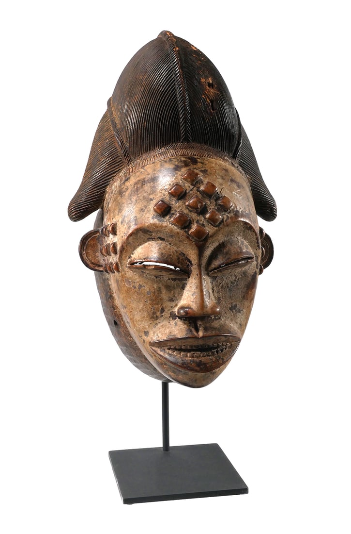 PUNU GABON AFRICAN MASK: Carved wood mask in the form of a human face with sculptured hair in a traditional design. Punu Peoples Gabon style mask. Approx. 19"H x 9"W. This item will need to be shipped by a packing company of