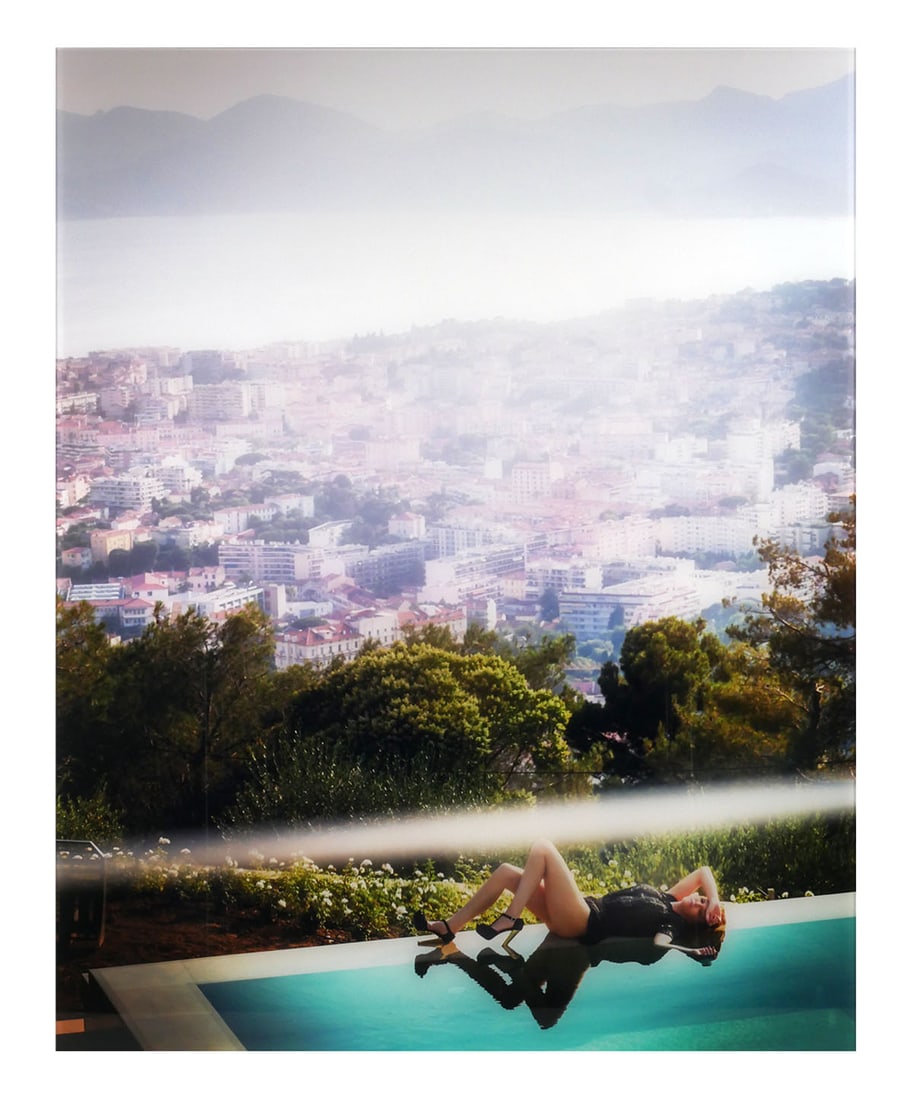 DAVID DREBIN, DREAM OF CANNES: Large digital C print photograph mounted under Plexiglas, of a female figure by the pool with city in the background by the photographer David Drebin, the work is titled "Dreams of Cannes", dated 2013