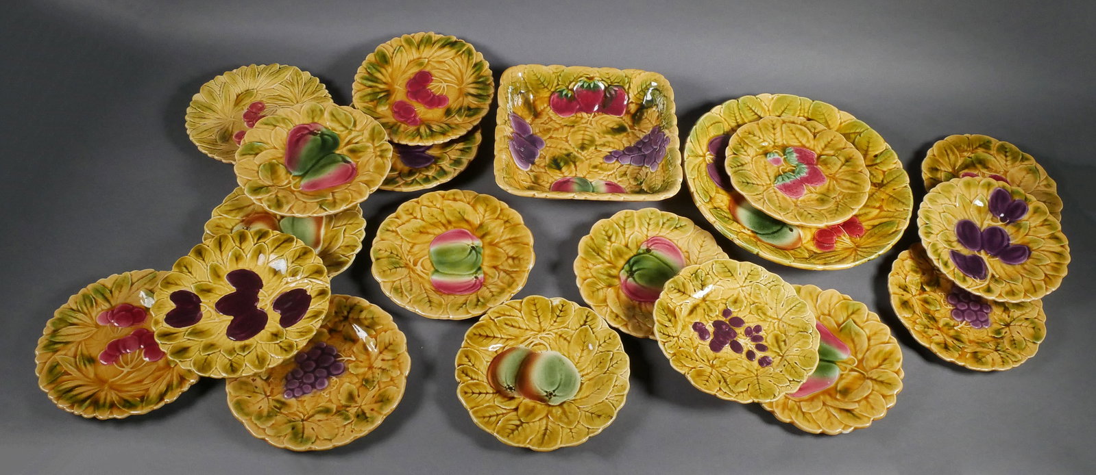 (19) SARREGUEMINES MAJOLICA DESSERT SET: Sarreguemines France Majolica fruit, pie, or dessert set, decorated with various fruits. Early 20th C. Square dish 9-3/8"square, platter 12"Dia, plates 7-5/8"Dia. This item will need to be shipped by 
