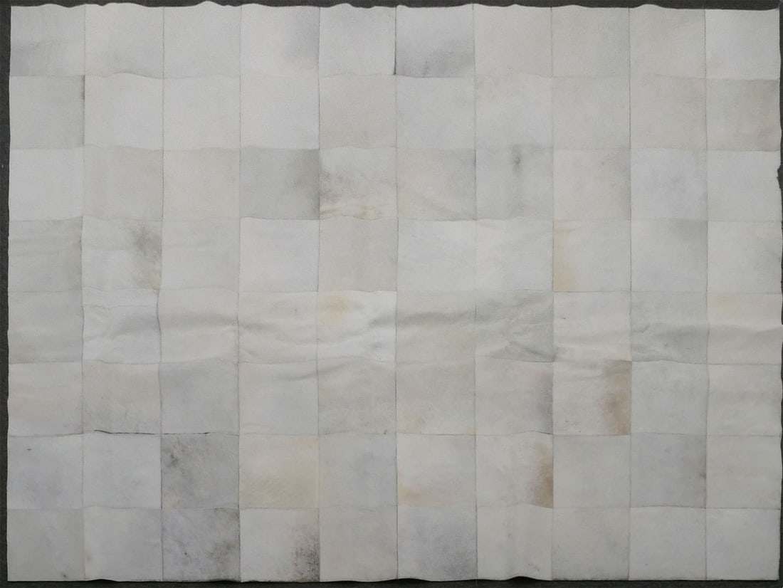 MODERN COW SKIN RUG: Design Within Reach large area rug. Square cowskin leather design. Rug measures approx. 115-1/2" X 93". This item will need to be shipped by a packing company of your choice. We maintain a list of rel