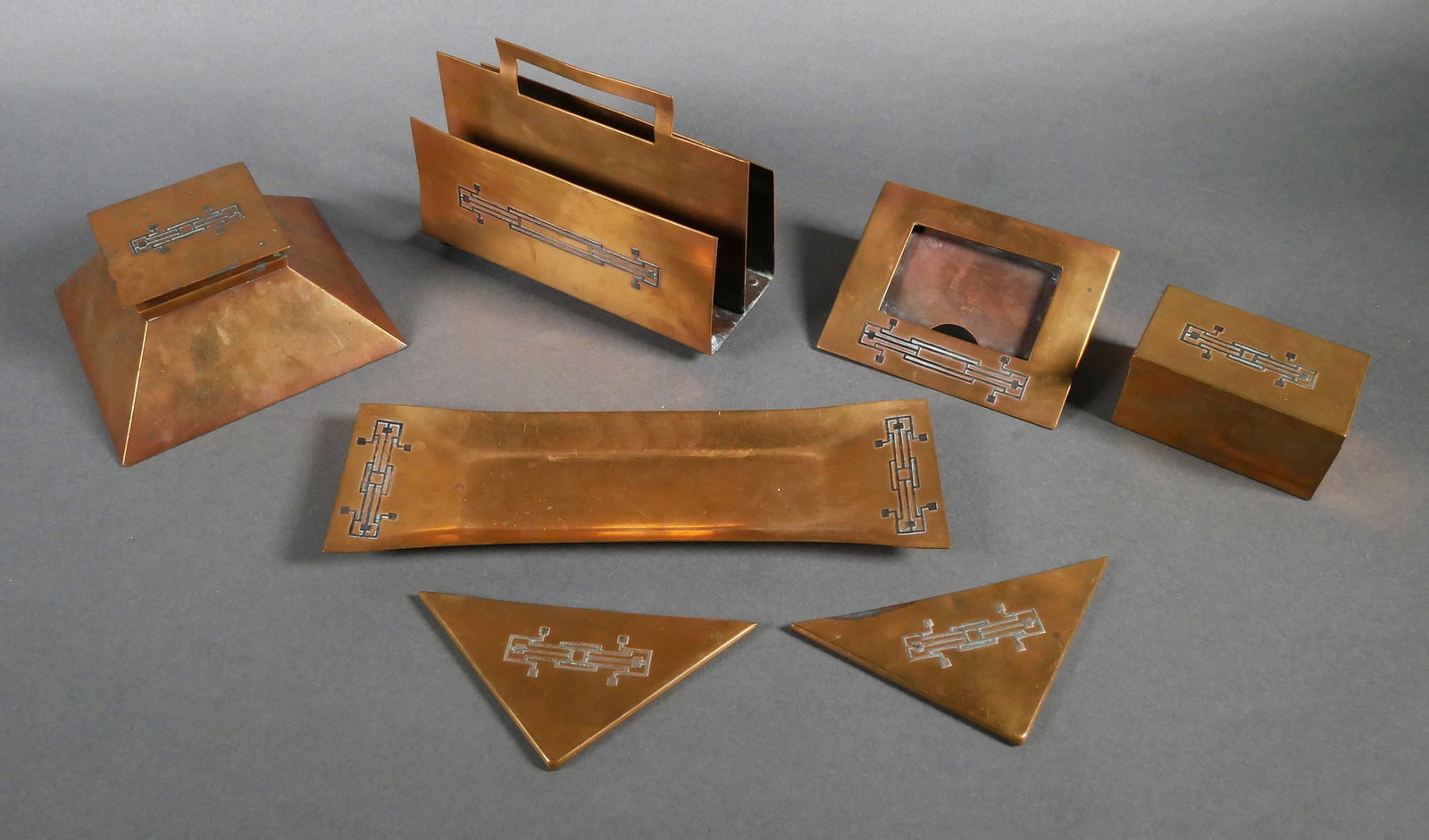 (7) Heintz Art Metal Sterling on Bronze Desk Set: (7) Piece Heintz art metal sterling on bronze desk set. The desk set has elements of Art Deco and Arts & Crafts designs. Includes inkwell, letter holder, (2) desk pad corners, lidded box, pen tray, an