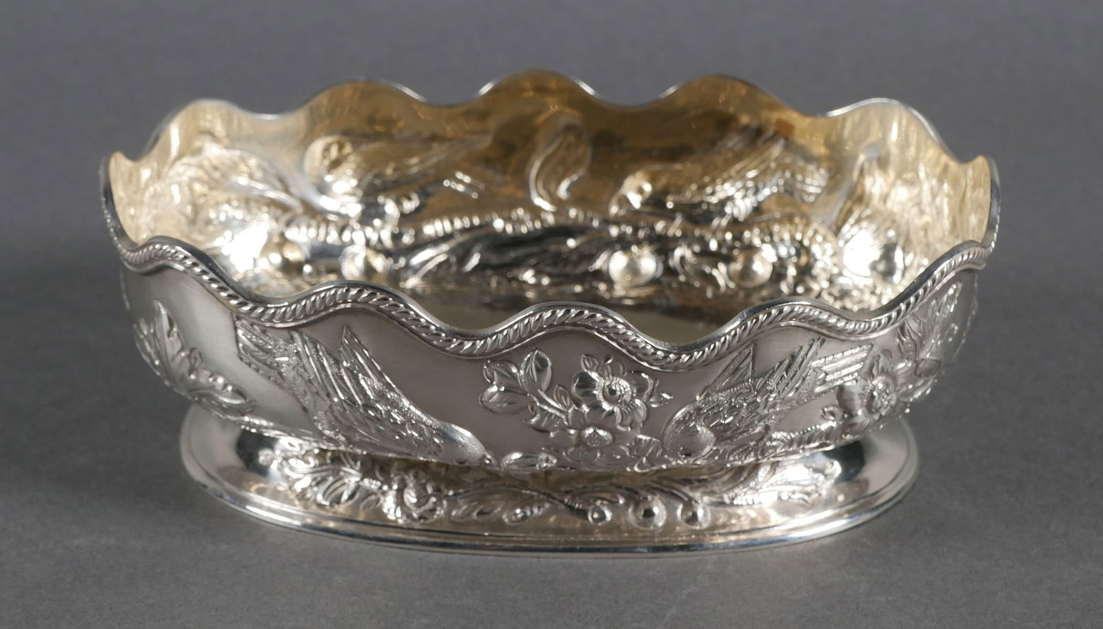 CHARLES STUART HARRIS Sterling Repousse Bowl: Antique English repousse sterling silver bowl by British silversmith Charles Stuart Harris, circa 1891. Repousse features birds on fruit tree. London hallmark. Bowl measures 5-5/5" wide x 2" tall x 3-