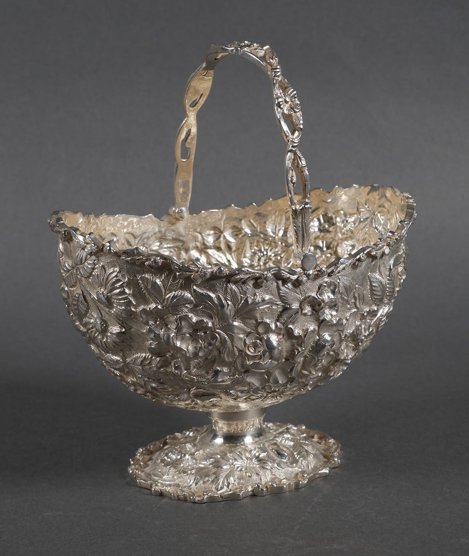 S. KIRK & SON Sterling Repousse Basket 10 ozt: Sterling silver S. Kirk & Son handled basket with repousse flower design. Marked "83 S Kirk & Son Co 925/1000". 7" to top of handle x 5-3/4" long x 4" deep. Weight 10.67 ozt. This item can be shipped 