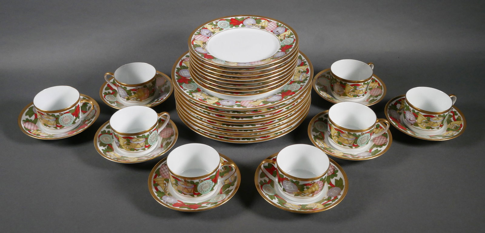 CHRISTIAN DIOR Christmas China Set: Mint "Dior Christmas" fine porcelain 32-piece dinner service for eight by Christian Dior, including dinner plates, salad/dessert plates, and cups and saucers. Dinner plates measure 11" in diameter. Th