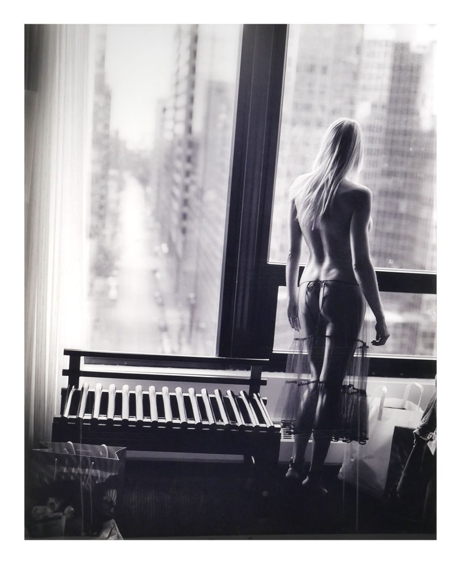 DAVID DREBIN, Tiffany at Window: Large digital C print photograph mounted under Plexiglas, of a female figure at a window looking down on a city by the photographer David Drebin, the work is titled "Tiffany at Window," dated 2004. Th