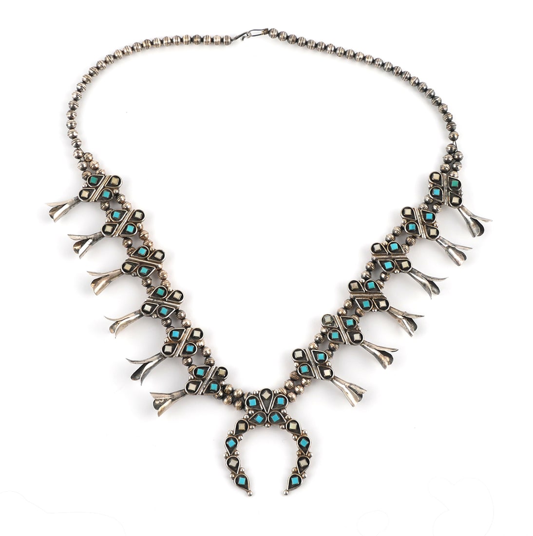 ELLIOT GASPAR Squash Blossom Necklace: Sterling silver 925 turquoise and mother of pearl squash blossom necklace. Unusual size and design, more delicate than most. Square cut turquoise and mother of pearl, each set into a teardrop shadowbo