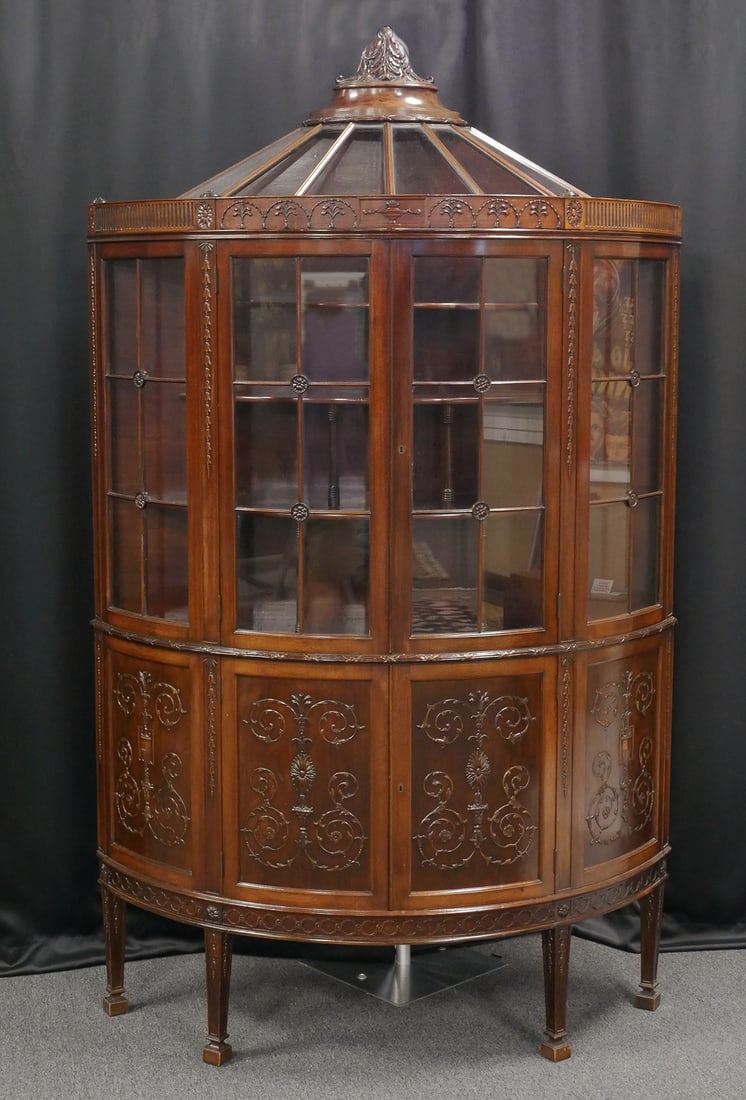 Large Vintage Mahogany Demilune Cabinet: 20th century mahogany demilune display cabinet. Unusual domed glazed faceted top. French Neoclassical inspired style with three graduated tiered demilune shelves behind glass doors. Blind cabinet belo
