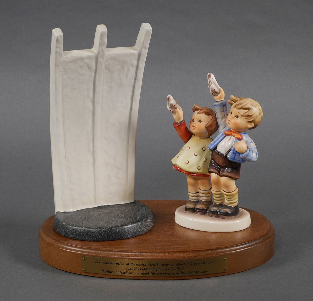 Hummel "Berlin Airlift": Goebel Hummel porcelain figural group, titled "Berlin Airlift" or "Berlin Airlift Memorial", honoring the Berlin Airlift. Composed of two pieces - "Auf Wiedersehen" and a replica of the Airlift Memori