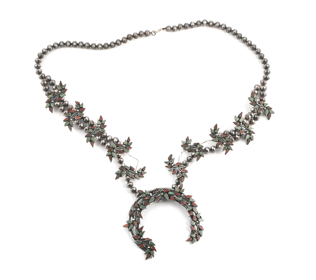 Squash Blossom Necklace Inlaid Design: Native American Indian Southwest Navajo design squash blossom necklace. Antique early to mid 20th century, decorated with inlaid green stones, assumed to be turquoise, and red coral or spiny oyster, a