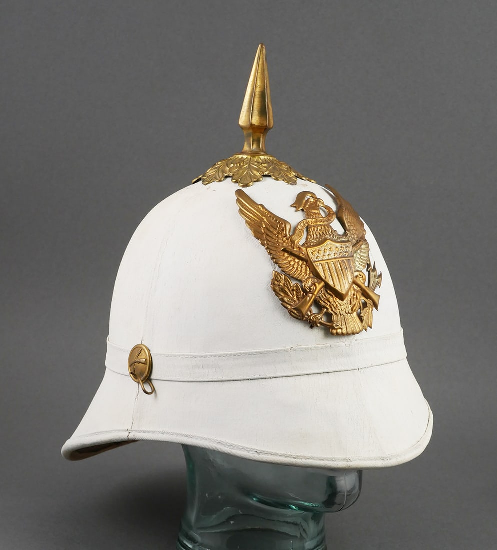 Antique US Model 1881 Infantry Dress Helmet: Presumed to be an original US Model 1881 "Summer White" Infantry dress spiked pith helmet. Measures approx. 11" tall x 12" long x 8" wide. This item can be shipped in-house.