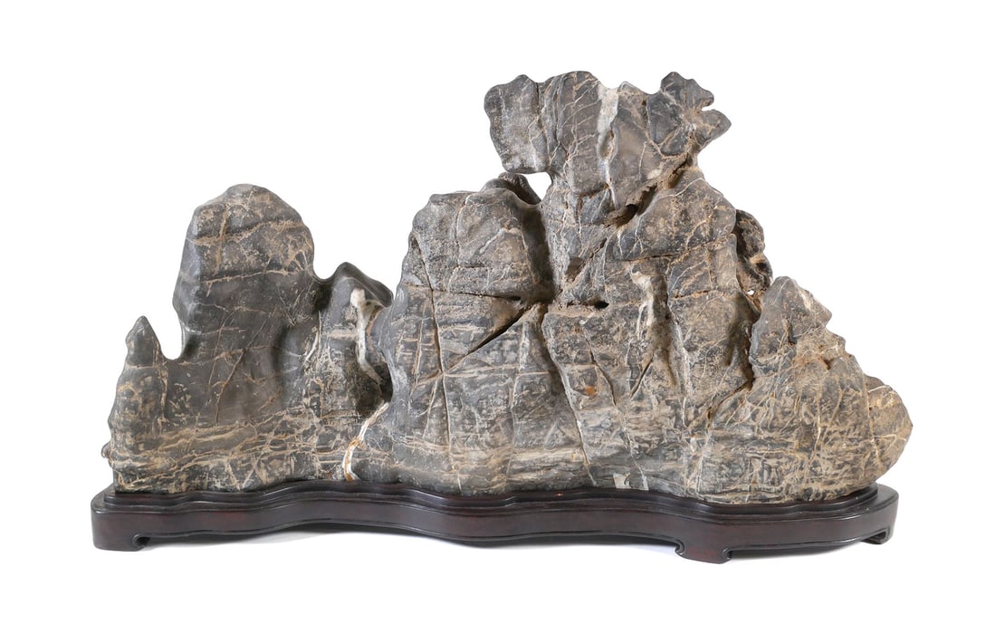 Chinese Scholar's Stone 24": Seiseki scholar's rock or gongshi on a carved wooden base. Viewing stone on base measures approx. 24" wide x 14" tall x 5-1/2" deep. Weight approx. 45 lbs. This item will need to be shipped by a packi