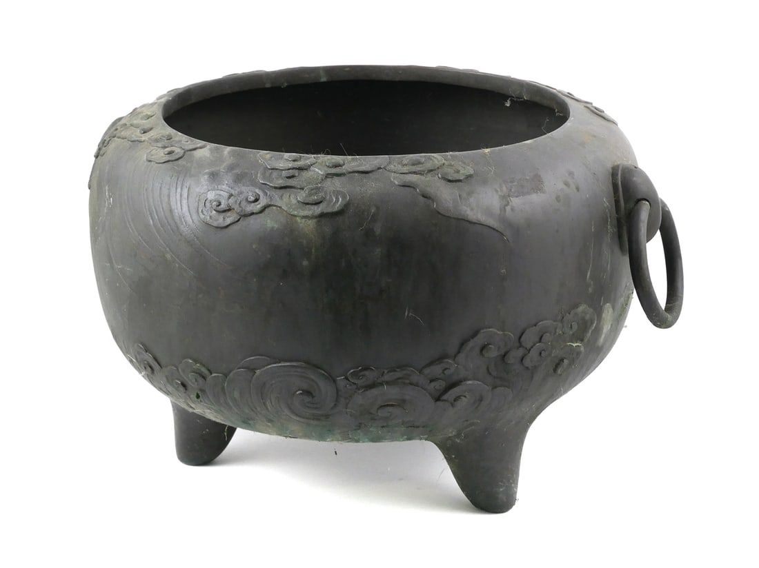 Antique Japanese Bronze Jardiniere: Bronze Japanese jardiniere likely from the Meiji period. jardiniere features a raised dragon motif to one side with two loop handles (missing one ring) and standing on three legs. Approx. 15" diameter