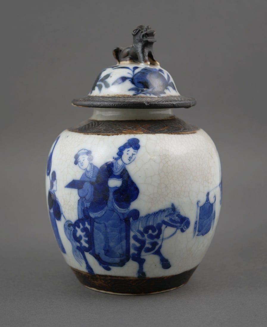 Chinese 19th Century Covered Jar: Qing Dynasty, blue and white glaze 19th century antique Chinese covered tea, ginger, or general jar. Decorated with figures and animals in blue against a white crackle background, lid with fu lion / d