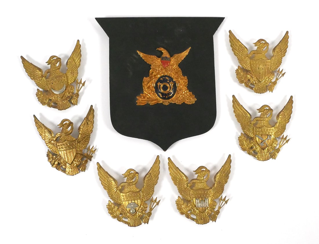 U.S. Shako Badges (7), incl early 19th Cent: Seven U.S. shako badges circa 1850s type. One of them, the plaque-mounted one, dates from the mid-19th century period. The rest are -- based on their construction -- presumed to be replicas. This item