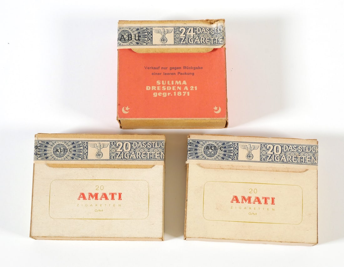 WW2: Nazi Revenue Stamped Cigarette Packs (3): Three WWII era sealed boxes of Amati or Sulima Orient Cigarettes with intact German Third Reich World War II revenue stamps printed with the Nazi eagle and swastika. Boxes approx. 3-1/4" x 2-3/8". Thi