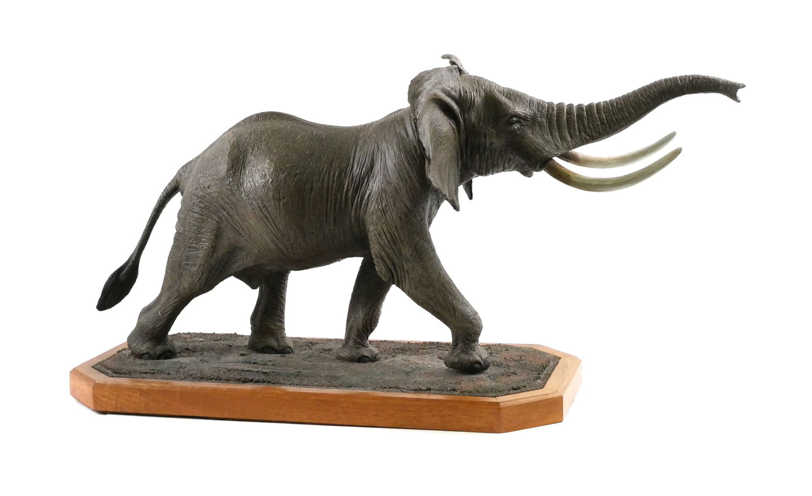 Louis Paul Jonas Elephant Sculpture: Limited edition elephant sculpture by Louis Paul Jonas Studios. Marked "LE 316/500" and signed on base. Mounted on shaped wood plinth. Measures approx. 34" long x 12" x 17" tall. Small chip to ear edg