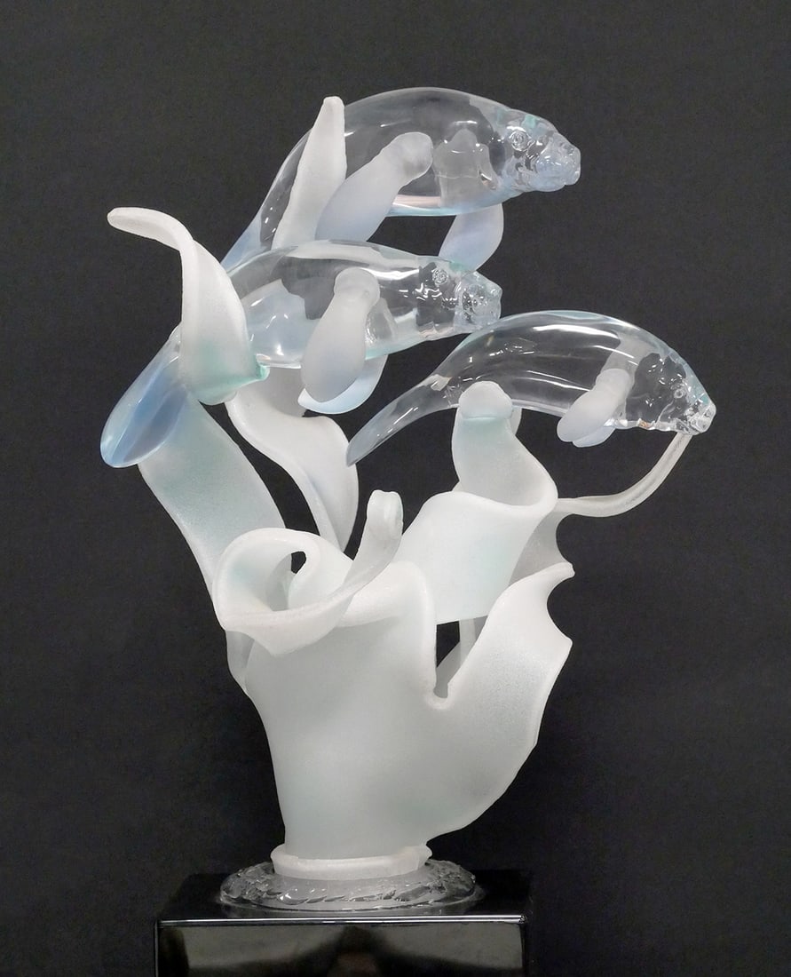 Lighted Lucite Sculpture of Three Manatees: Signed sculpture of three manatees in clear and frosted Lucite mounted on a black base with integral lighting. Signed by Barry Cohen. Measures approx. 27" tall x 15" x 16". TAGS: acrylic marine displa