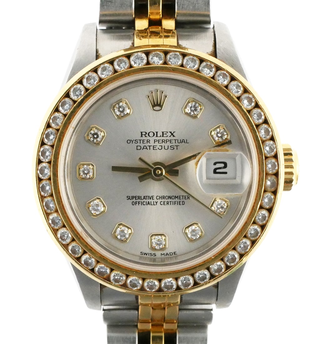 Rolex Oyster Perpetual Datejust 27mm Two-Tone: Ladies' or women's Rolex Oyster Perpetual Datejust wristwatch with 27mm stainless steel case and 18k yellow gold aftermarket bezel set with 41 round-cut diamonds. Silver-tone dial marked "Rolex Oyster