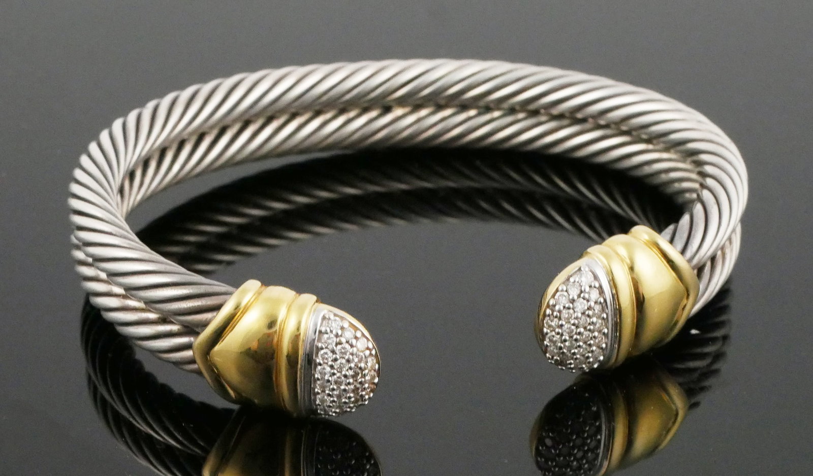 DAVID YURMAN 18K Diamond Sterling Bracelet: Yurman diamond and 18 karat yellow gold accented sterling silver cable cuff bangle bracelet. 53.04 grams tw, approx. 6-5/8" total inner dia, 5/8" opening. This item can be shipped in-house.