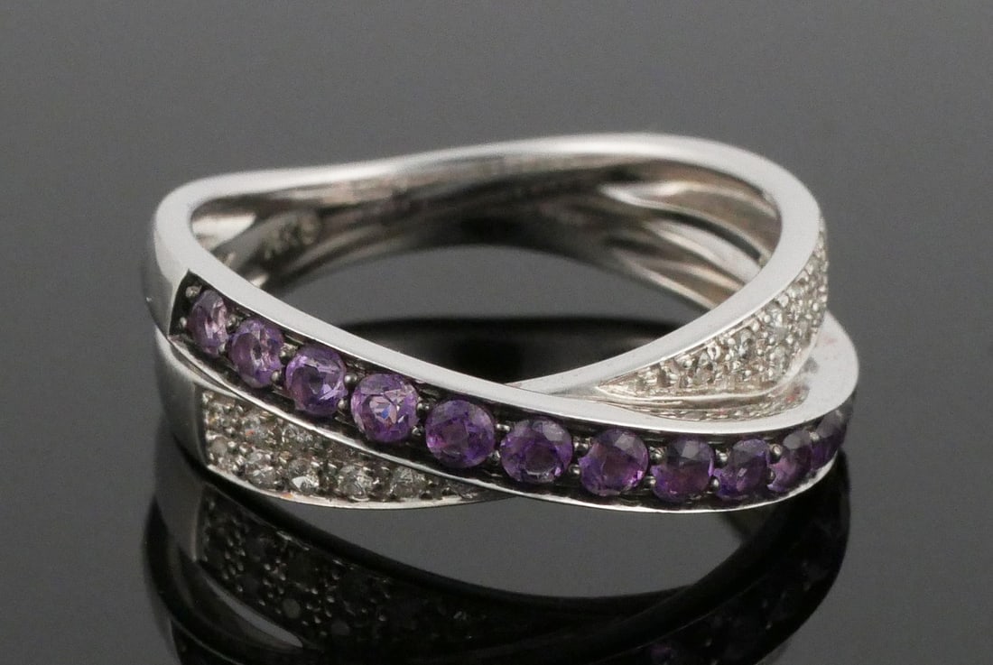 14K Gold Diamond Amethyst Ring: 14 karat white gold diamond and amethyst band. Crossover design, 3.88 grams tw, size 6-1/5. This item can be shipped in-house.
