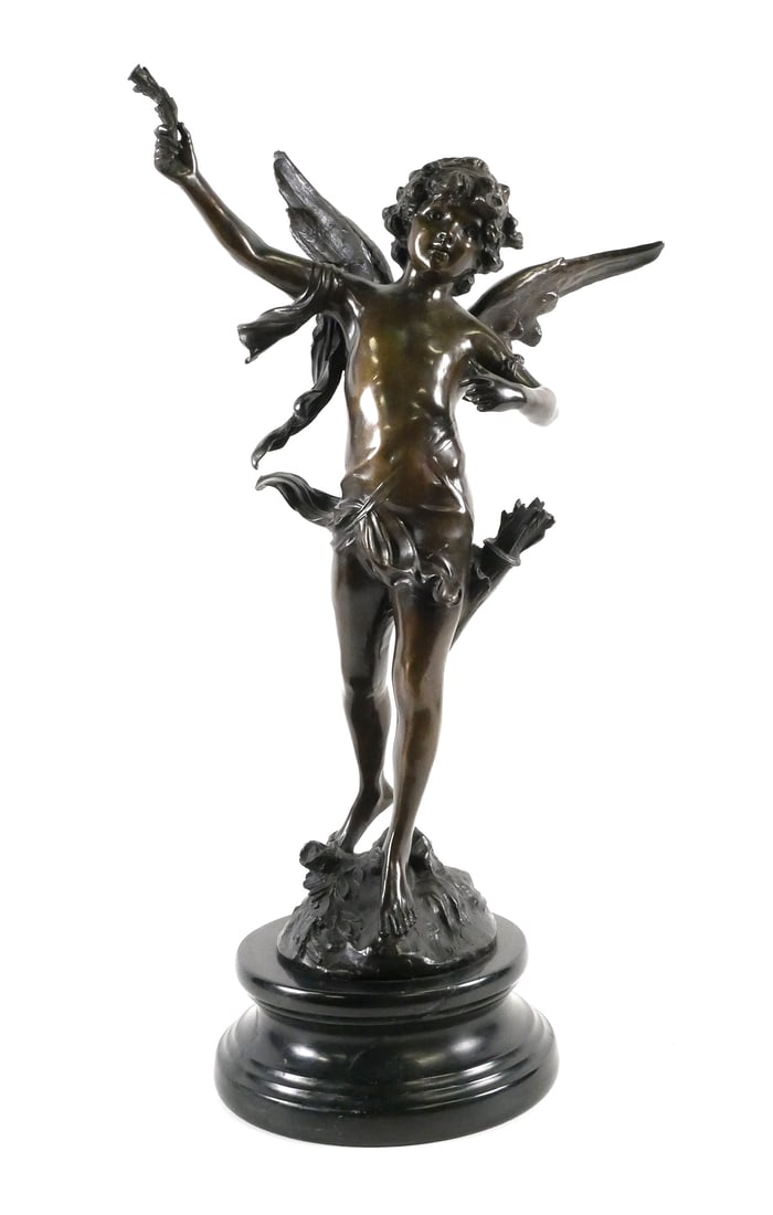 Bronze Winged Cupid Figure After Moreau: Patinated bronze sculpture of a winged figure on round black marble plinth. Signature on base is present but illegible. Style is similar to works by Auguste Moreau. Measures approx. 28-3/4" tall x 15"