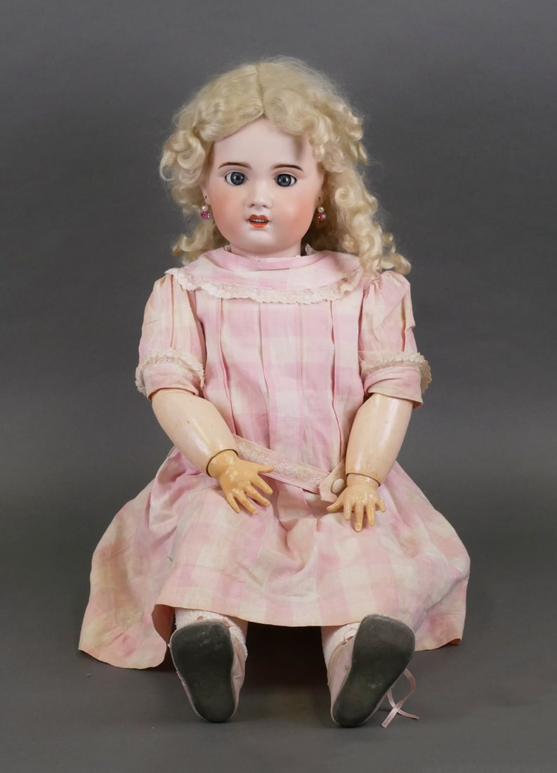 JUMEAU 27" French Bebe Doll: S.F.B.J. bebe doll with porcelain bisque head and composition body. Socket head with sleepy blue paperweight glass eyes, open mouth with teeth, chin dimple, and pierced ears stamped in mold "S.F.B.J P