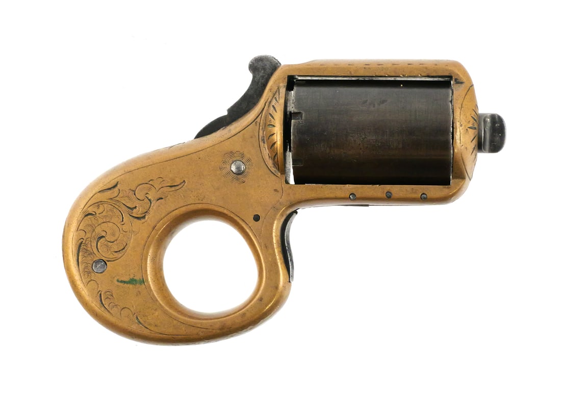 James Reid Knuckle Duster Revolver: James Reid Knuckle Duster revolver, also known as the "My Friend". Features a brass frame with engraved scrollwork and patented Dec. 26, 1865 marking. Serial number 5075. Cylinder measures 1.43", appr