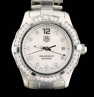 TAG HEUER Diamond Aquaracer Watch: Tag Heuer women's Aquaracer watch. Mother of pearl dial with diamond hour markers, 30mm stainless steel case with a unidirectional diamond bezel, and stainless steel bracelet. Currently fits an