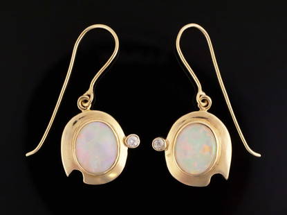 14K Gold Opal Diamond Earrings: 14 karat yellow gold earrings set with opal and diamonds. Asymmetrical modernist design, pierced drop earrings with hooks. 3.81 grams tw. This item can be shipped in-house. Multiple lot combined