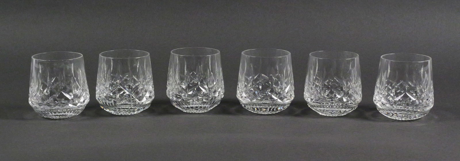 6 Waterford Lismore Roly Poly Crystal Glasses: Set of six Waterford crystal "Lismore Roly Poly" old fashioned glasses, featuring the classic diamond and wedge cut pattern. Each glass measures approximately 3-1/4" tall. TAGS: rocks glasses, whiskey