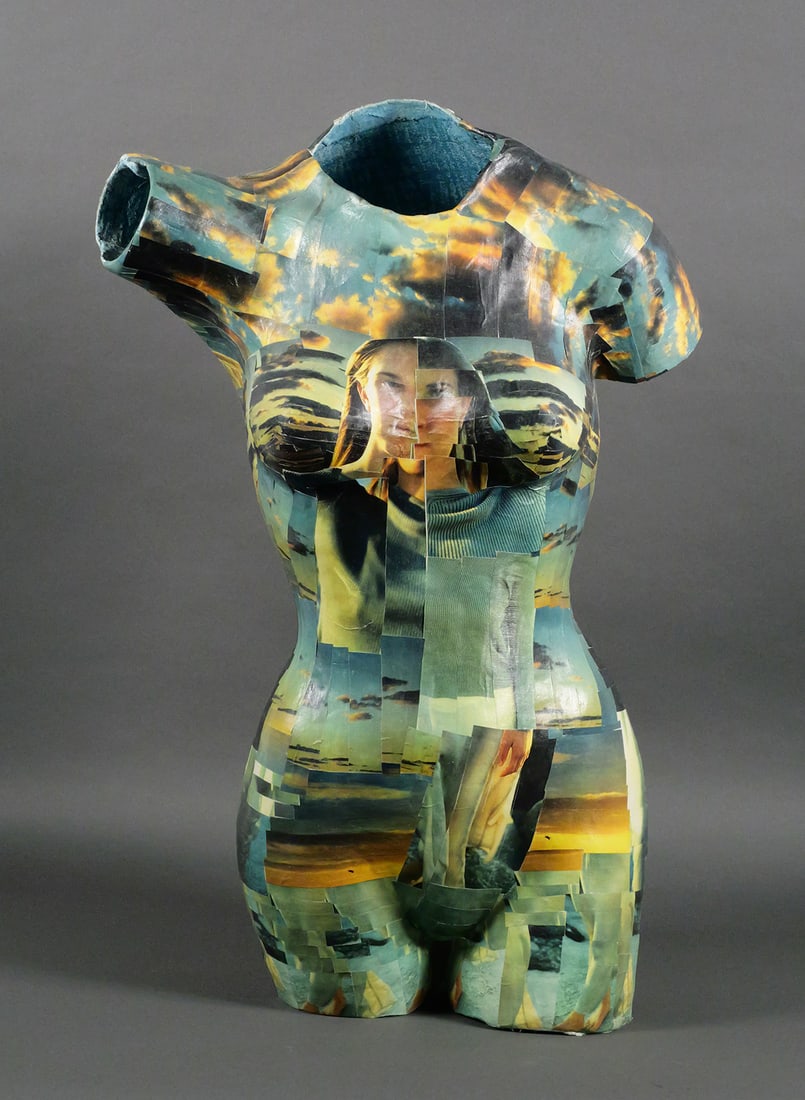 Katie M. Higgins Mixed Media Torso: Mixed media sculpture by Katie M. Higgins depicting a female torso form with collage-style photographic overlay. Features fragmented images of a woman and sky landscapes across the surface. Signed on
